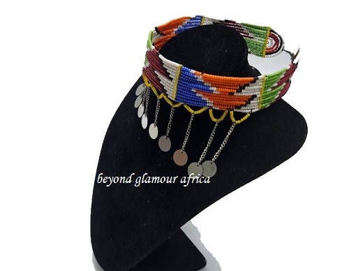 A laege green and maroon yellow neck choker with dangling silver decorations