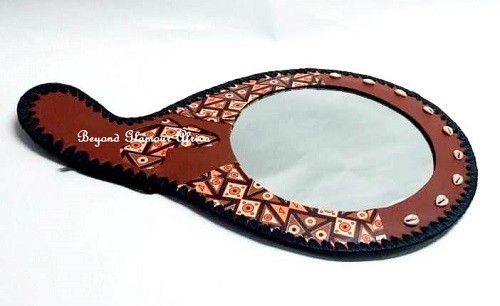A customized brown leather African mirror