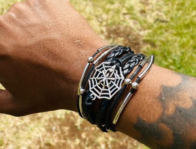 A multi-strand leather bracelet adorned with cobweb decorations