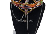 A big green red head gear with silver daggling decoration