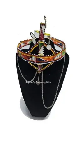 A big green red head gear with silver daggling decoration
