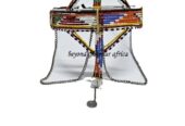 A orange blue maasai head gear with some silver daggling decorations