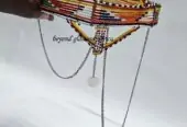 A big green red head gear with silver daggling decoration