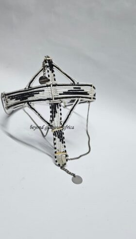 A black and white maasai head/face gear with some silver decorations