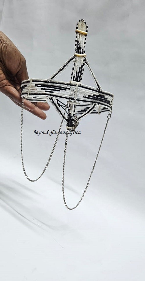 A black and white maasai head/face gear with some silver decorations