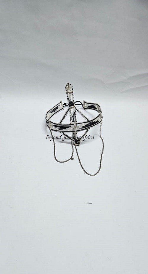 A black and white maasai head/face gear with some silver decorations