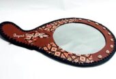 A customized brown leather African mirror