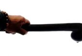 A men’s black wooden rungu