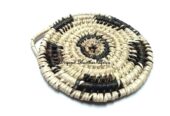 A hand woven black and white coaster