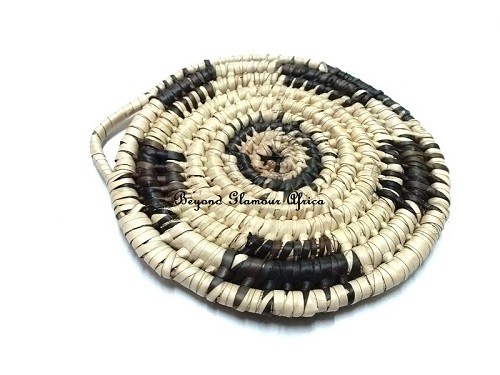 A hand woven black and white coaster