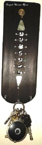 A black wall mounted wooden key holder very fashionable
