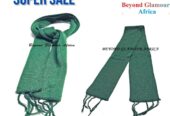 A green knitted scarf very fashionable and warm to have.