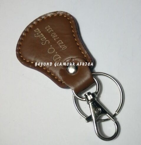 A brown cowboy hat and a brown keyholder combo very fashionable to have